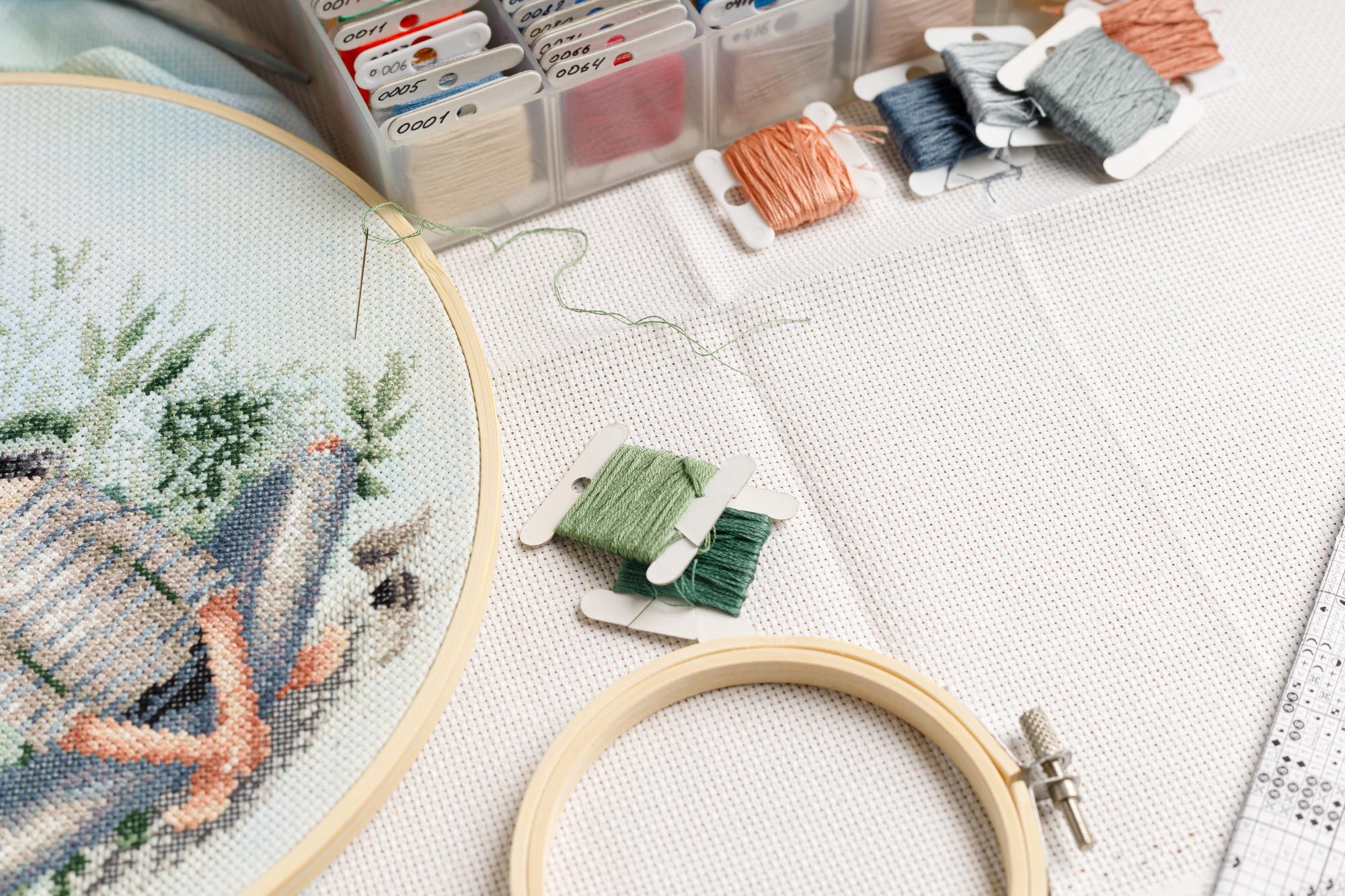 Studio workspace with threads and hoops on table