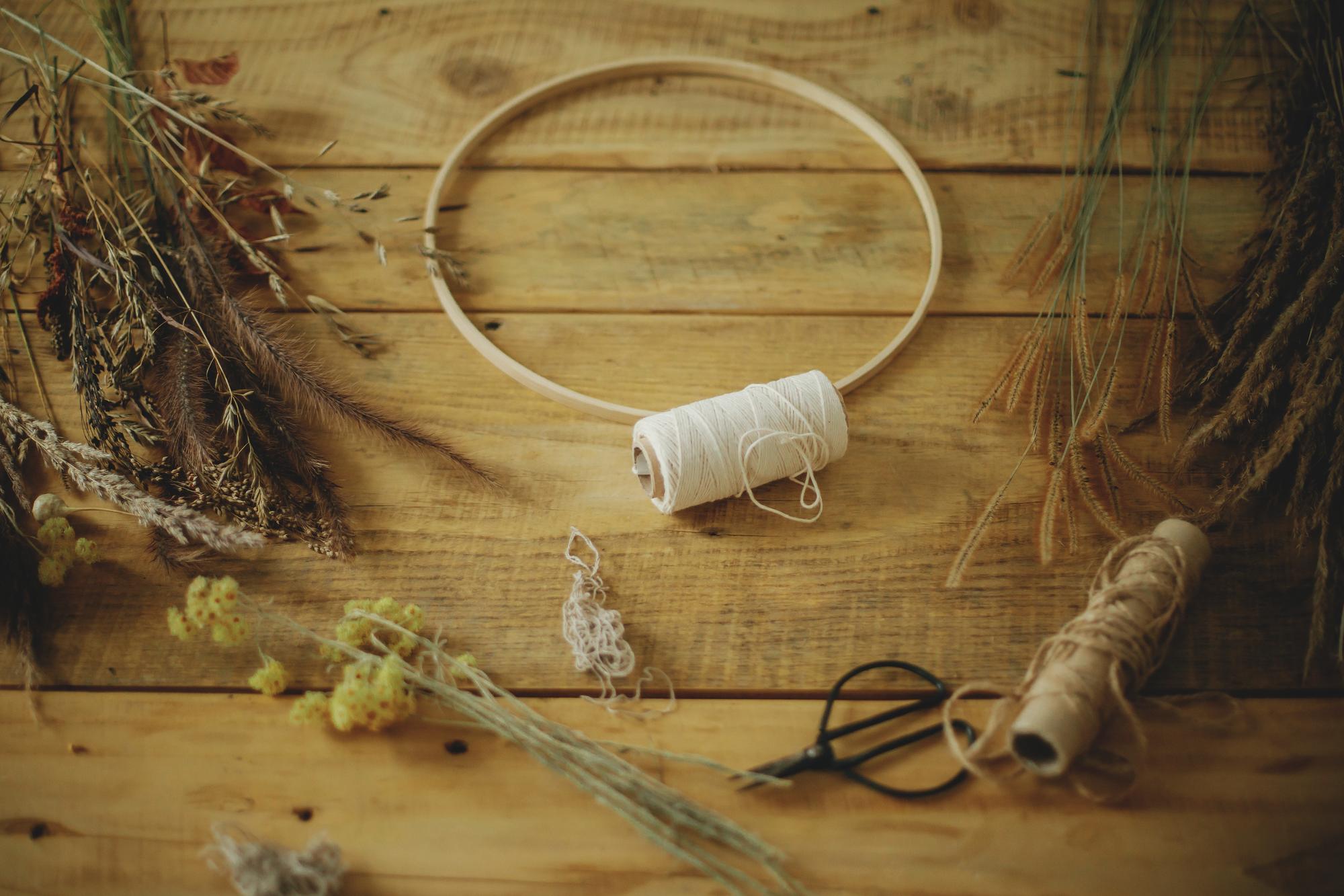 Workshop table with embroidery hoops and threads