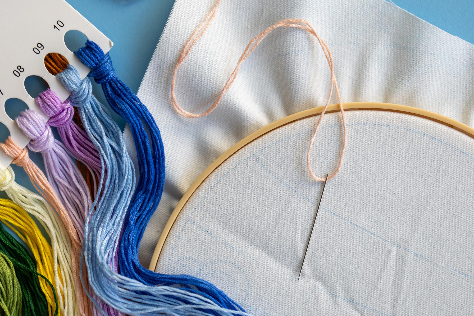 Close-up of colorful hand embroidery on linen